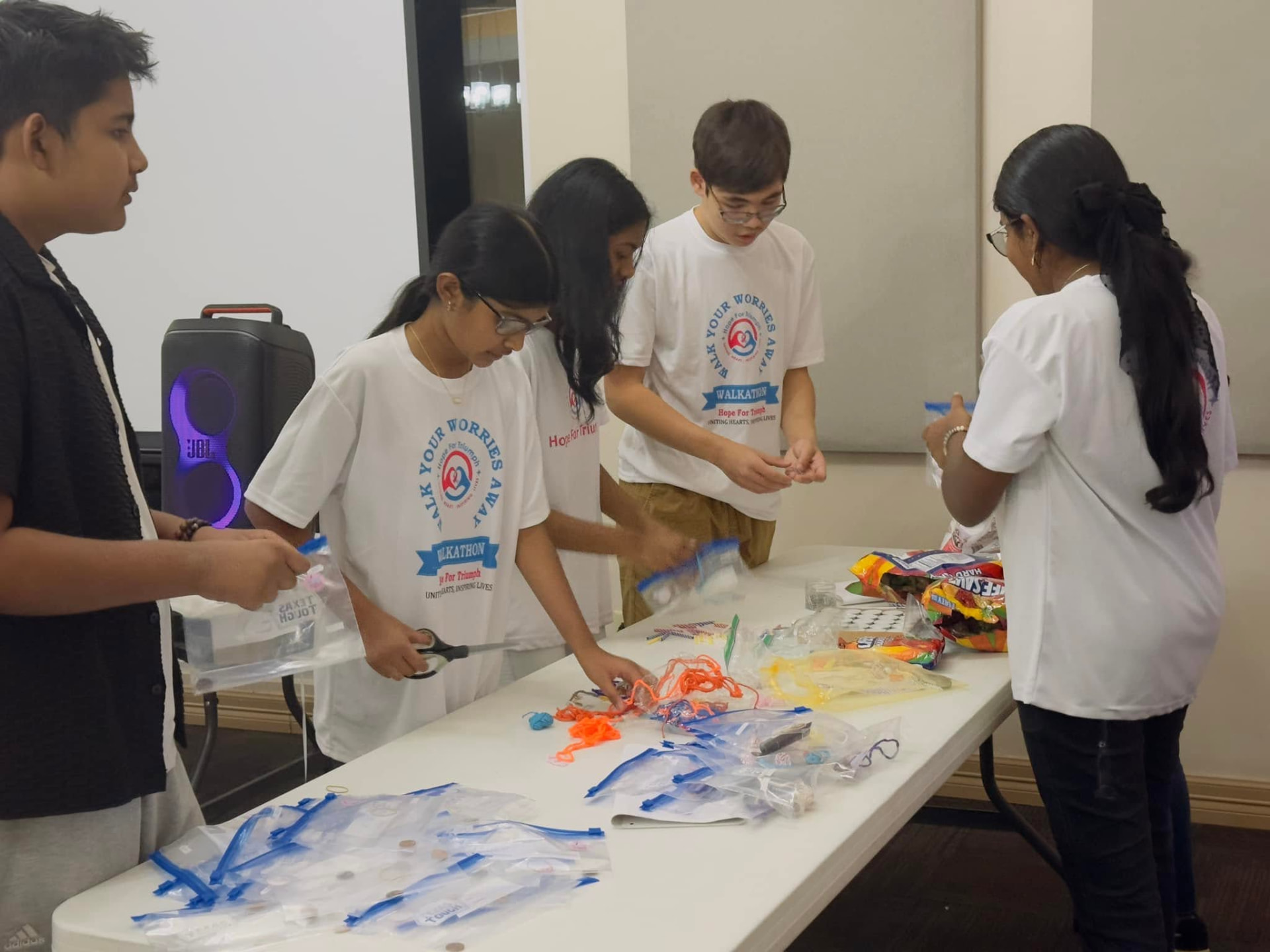 Student volunteers packing Hope Care Kits with toiletries and handwritten cards